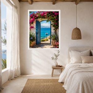 May include: A framed wall art print depicting an open blue door leading to a Mediterranean coastal view with bright pink bougainvillea flowers, a small white boat on turquoise water, and a stone pathway, displayed in a bedroom setting.