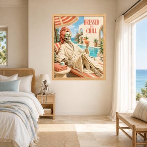 May include: A framed wall art print featuring a skeleton wearing a beige bathrobe, a pink towel wrap, and cucumber slices over its eyes. The skeleton sits on a lounge chair by a pool, holding a cocktail, with the text DRESSED TO CHILL above.