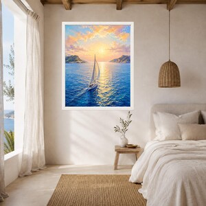 May include: A framed wall art print depicting a white sailboat navigating deep blue ocean waters under a vibrant sunset sky with golden clouds. The scene features distant coastal hills on the horizon, with the sun casting a bright reflection.