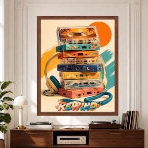 Framed Rewind cassette tape wall art featuring a colorful stack of retro mixtape cassettes with oversized headphones, coiled audio cable, orange sun and teal graphic brushstrokes.