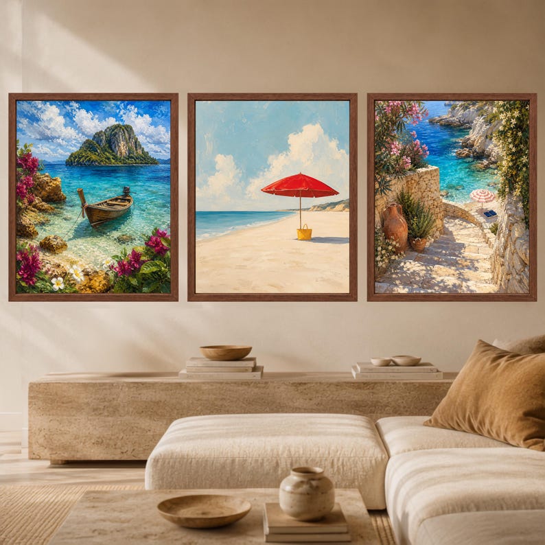 May include: A set of three framed wall art prints featuring coastal scenes. The left print shows a wooden boat in turquoise water with pink flowers. The center print depicts a red beach umbrella on sand. The right print shows a stone staircase.