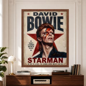 Framed David Bowie Starman wall art featuring Bowie with lightning-bolt makeup against a large red star, bold retro typography and distressed cream, black and red 1970s poster styling.