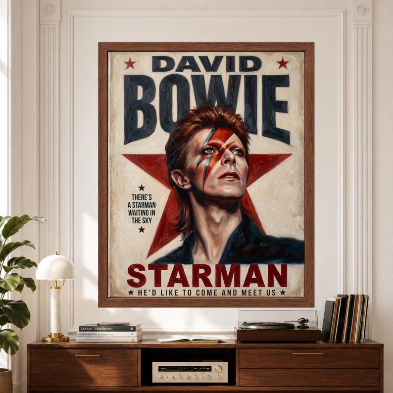 Framed David Bowie Starman wall art featuring Bowie with lightning-bolt makeup against a large red star, bold retro typography and distressed cream, black and red 1970s poster styling.