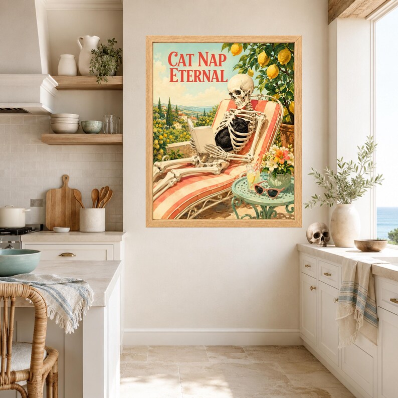 May include: A framed wall art print titled CAT NAP ETERNAL featuring a skeleton reclining in a striped lounge chair while reading a book, surrounded by lemon trees, a small table with a drink, and sunglasses, all set in a sunny outdoor scene.