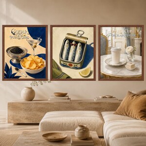 May include: A set of three framed wall art prints. The left print shows caviar, potato chips, and a martini with the text Caviar & Potato Chips. The center print depicts sardines in a tin with a lemon wedge. The right print shows a paper cup on a saucer.