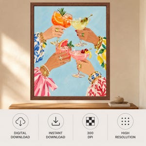 May include: A framed art print depicting four hands raised in a toast, each holding a different cocktail in a stemmed glass. The drinks are garnished with citrus slices, cherries, and herbs. The hands wear gold bracelets and rings against a light blue background.