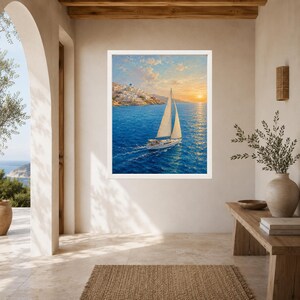 May include: A framed wall art print featuring a sailboat navigating deep blue waters at sunset. The scene includes a white sailboat with sails unfurled, moving toward a coastal hillside town with white buildings under a warm, golden sky.