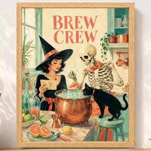 May include: A framed wall art print titled BREW CREW featuring a witch in a black hat and a skeleton wearing a red bow tie standing behind a copper cauldron. A black cat sits on a stool next to the cauldron, which contains a light blue liquid.