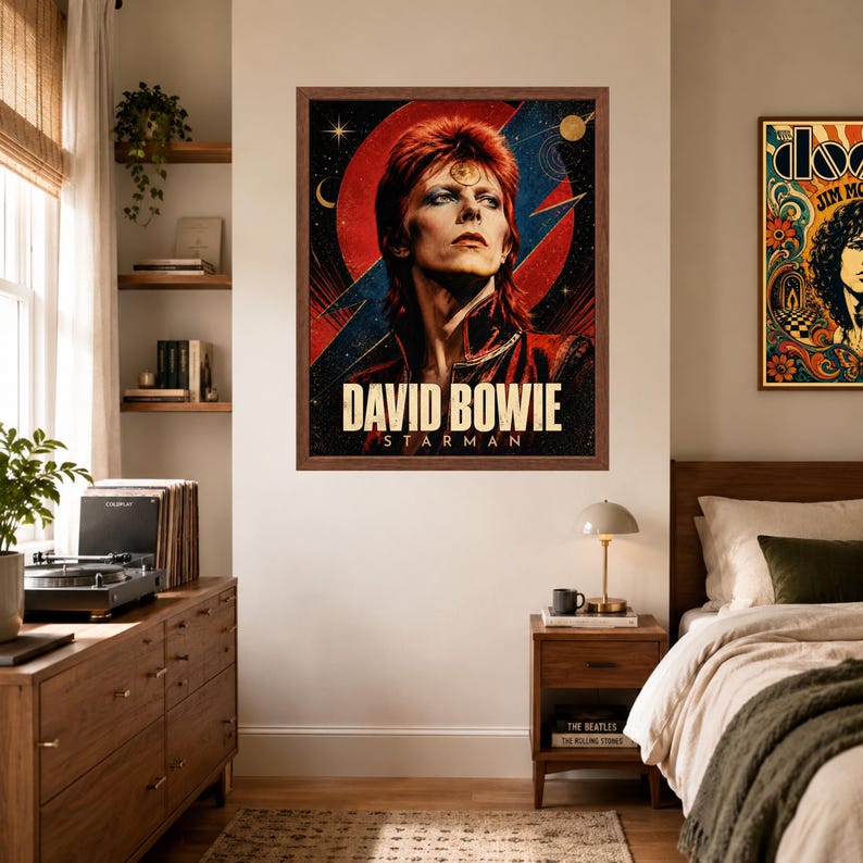 May include: A framed rectangular wall poster featuring a portrait of David Bowie with red hair and makeup, set against a dark background with a large red circle, blue lightning bolt, and stars. The text DAVID BOWIE STARMAN is printed in white.