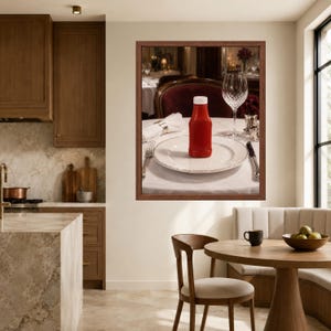 May include: A framed wall art print depicting a formal dining table setting with a white tablecloth, a white dinner plate, a red plastic ketchup bottle with a white cap, a crystal wine glass, a silver fork, and a silver knife.