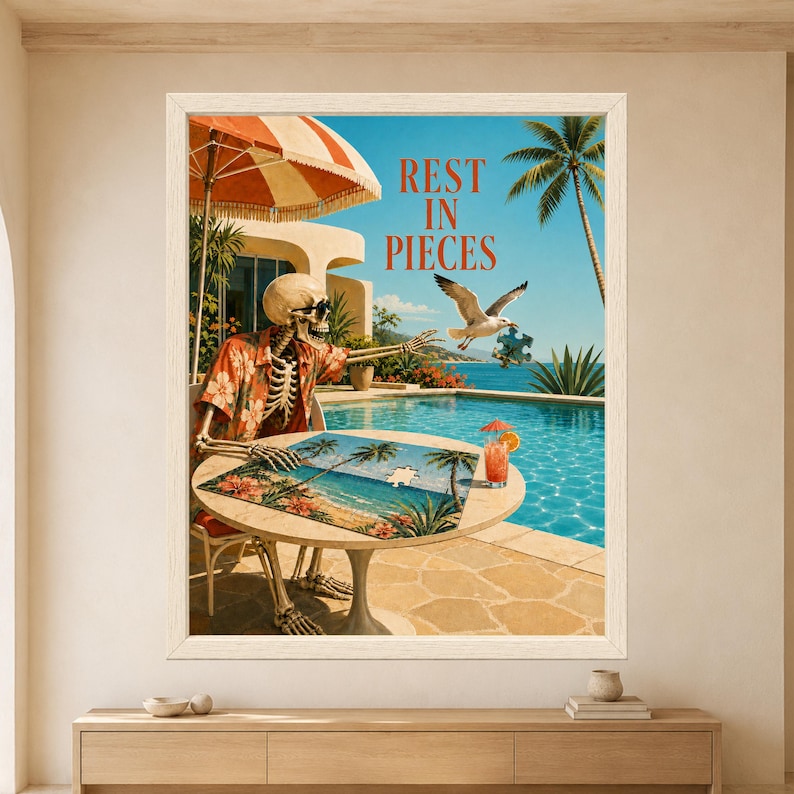 Framed Rest in Pieces skeleton wall art featuring a sunglasses-wearing skeleton completing a tropical puzzle beside a turquoise swimming pool while a seagull flies away carrying a missing puzzle piece.