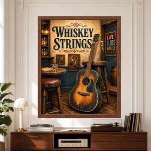 Framed Whiskey Strings blues wall art featuring a weathered acoustic guitar in a rustic bar with wooden stools, whiskey glass, vintage blues portraits, distressed blue walls and a Live Blues Nightly sign.