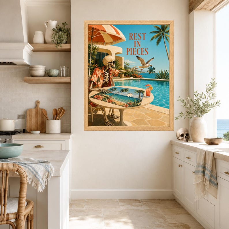 May include: A framed wall art print featuring a skeleton wearing a floral shirt and sunglasses, sitting at a round table by a swimming pool. The skeleton is working on a puzzle while a seagull flies nearby. The text REST IN PIECES is visible.