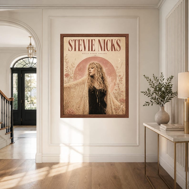 May include: A framed wall art print featuring a portrait of Stevie Nicks with the text STEVIE NICKS and BELLA DONNA DREAMS. The artwork displays a person with long wavy hair wearing a lace shawl over a black top, set against a large pink moon.