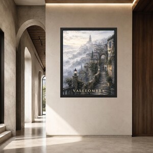 May include: A framed wall art print depicting a hillside town shrouded in mist, featuring stone staircases, archways, and glowing lanterns. The text VALLEOMBRA City Above the Silent Clouds is printed in gold at the bottom of the dark-framed artwork.