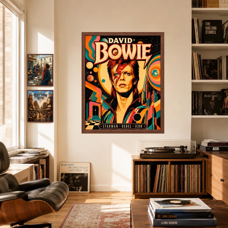 May include: A framed wall art print featuring a stylized portrait of David Bowie with a red lightning bolt across the face, surrounded by colorful cosmic graphics, planets, and the text DAVID BOWIE STARMAN REBEL ICON in a dark brown wooden frame.
