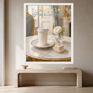 May include: A white paper cup with a lid sits on a white porcelain saucer on a marble table. Next to it is a small square cake and a glass vase with a white flower. The text PAPER CUP, PORCELAIN SAUCER is printed at the top of the framed print.