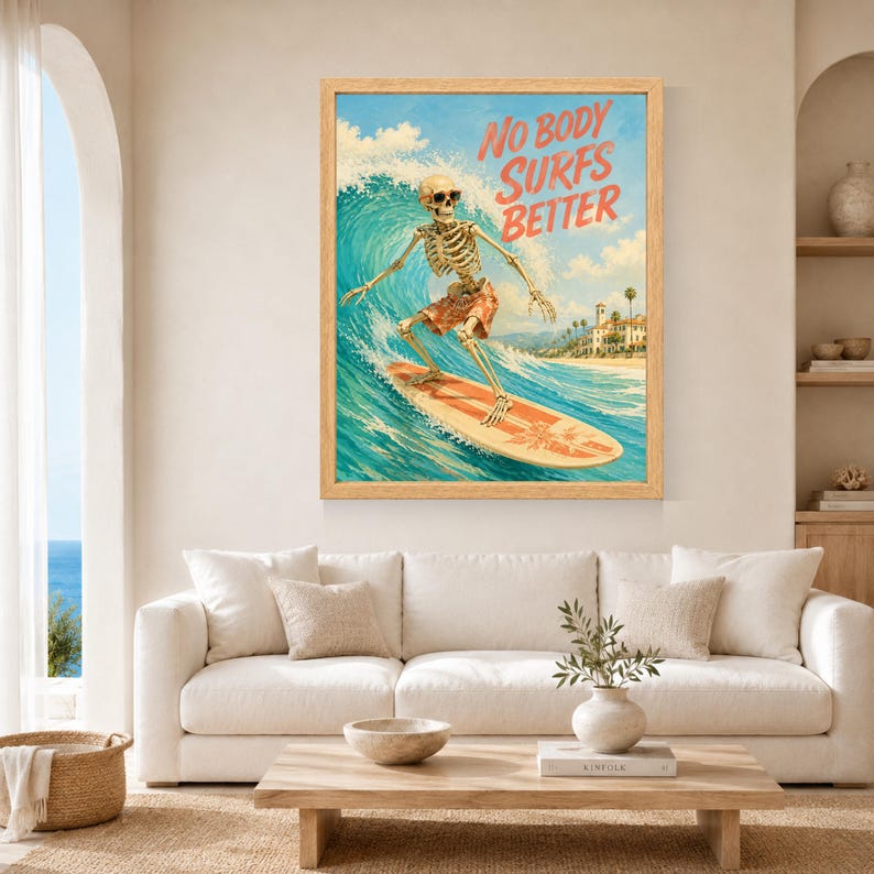 May include: A framed wall art print featuring a skeleton wearing sunglasses and orange patterned swim trunks while surfing on a surfboard. The blue ocean wave curls behind the skeleton, and the text NO BODY SURFS BETTER is printed in orange.