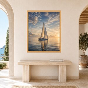 May include: A framed wall art print featuring a white sailboat on calm water during a golden sunset. The sky is filled with soft, wispy clouds reflecting warm light. The sailboat is centered, casting a clear reflection on the surface of the sea.