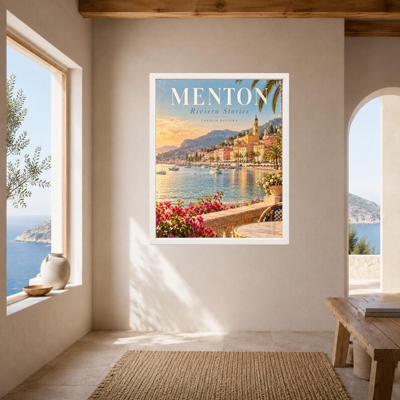 May include: A framed wall art print titled MENTON Riviera Stories French Riviera, featuring a coastal landscape with a Mediterranean town, a blue sea with boats, a stone terrace with pink bougainvillea flowers, and a warm sunset sky.