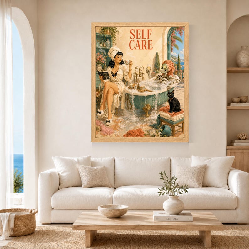May include: A framed wall art print titled SELF CARE featuring a vintage-style illustration of a person in a white robe reading a book next to a clawfoot bathtub containing a skeleton with a towel on its head and a black cat sitting nearby.