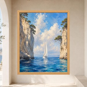 May include: A framed wall art print depicting a white sailboat navigating through a narrow passage between two tall, light-colored rocky cliffs topped with green trees, set against a bright blue sky with fluffy white clouds and deep blue water.