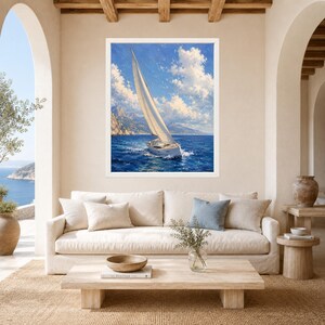 May include: A framed wall art print featuring a sailboat with a large white sail navigating deep blue ocean waters under a bright sky with fluffy white clouds, with distant rocky mountains visible along the horizon line in the background.