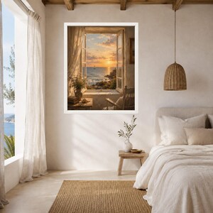 May include: A framed wall art print depicting an open window view of a sunset over the ocean with a sailboat on the horizon. The scene includes a wooden chair, a small table with a vase of flowers, and sheer curtains framing the coastal landscape.