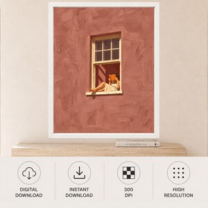 May include: A framed wall art print featuring a textured terracotta-colored wall with a white-framed window. A person sits in the window frame reading an orange book. The wall has visible brushstroke textures, and the window has a grid pane design.