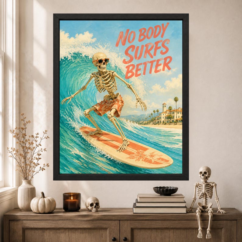May include: A framed wall art print featuring a skeleton wearing sunglasses and orange patterned swim trunks, surfing on a large ocean wave. The text NO BODY SURFS BETTER is printed in orange in the sky above a coastal building and palm trees.