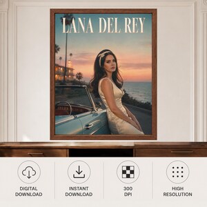 May include: A framed wall art print featuring Lana Del Rey in a cream-colored dress, leaning against a light blue vintage convertible car. The background shows a sunset over the ocean with palm trees. The text LANA DEL REY is at the top.