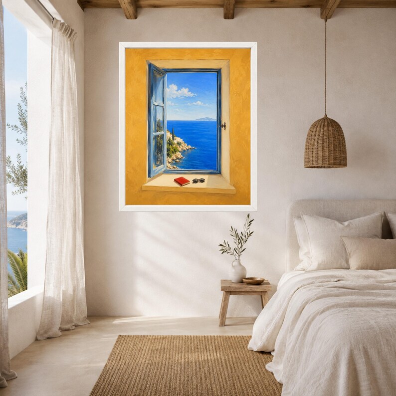 May include: A framed wall art print depicting an open window with a view of a bright blue sea and rocky coastline. The window frame is light blue, set against a textured yellow wall. A small red book and black sunglasses rest on the window sill.
