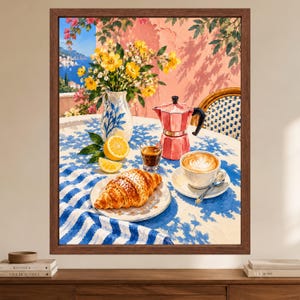 May include: A framed painting depicting a breakfast scene on a balcony with a blue and white striped tablecloth, a croissant on a plate, a cup of latte, a pink moka pot, a small glass of espresso, a lemon, and a vase of yellow flowers.