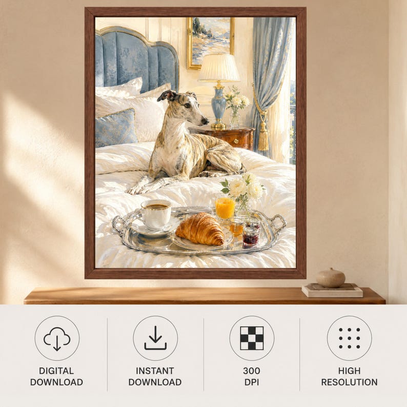 May include: A framed wall art print featuring a brindle greyhound resting on a white bedspread. A silver tray holds a cup of coffee, a croissant, a glass of orange juice, and a small vase of white flowers. The scene includes a blue headboard.