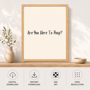 May include: A framed wall art print featuring a light cream background with the black text "Are You Here To Poop?" centered in the frame. The print is enclosed in a light-colored wooden frame, displayed on a shelf next to a small vase.