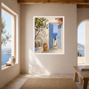 May include: A framed wall art print depicting a Mediterranean scene with an open blue door revealing a bright blue sea. A lemon tree with yellow fruit grows beside a stone bench with a striped cushion and a terracotta vase on a patio.