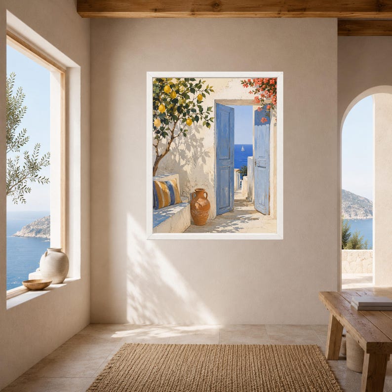 May include: A framed wall art print depicting a Mediterranean scene with an open blue door revealing a bright blue sea. A lemon tree with yellow fruit grows beside a stone bench with a striped cushion and a terracotta vase on a patio.