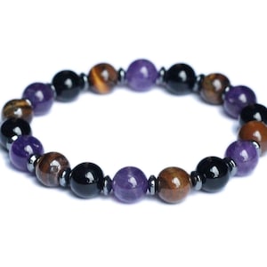 May include: A beaded bracelet with purple, brown, and black beads. The bracelet is made of amethyst, tiger's eye, and black onyx.