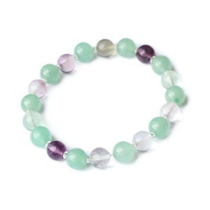 May include: A green and purple gemstone bracelet with round beads. The bracelet is made with a variety of green and purple stones.