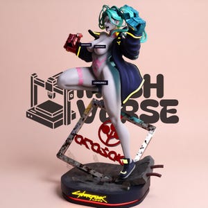 May include: A stylized figurine of a character with teal hair, wearing a dark jacket with yellow accents and red mechanical gloves. The figure stands on a base featuring a tilted square frame with the red text Arasaka and a Cyberpunk logo.