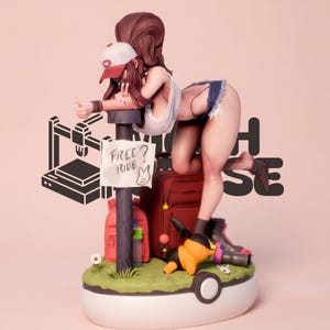 May include: A collectible figurine featuring a character with long brown hair wearing a white cap, white tank top, and denim shorts, leaning on a post with a sign that reads FREE RIDE. The base is shaped like a Poké Ball with a small creature, a red suitcase, and a red backpack.