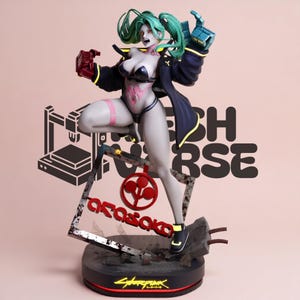 May include: A collectible figure of a character with teal hair, wearing a black bikini and a dark jacket, posed dynamically. The figure stands on a base featuring a square frame with the red Arasaka logo and text, plus a Cyberpunk logo at the bottom.
