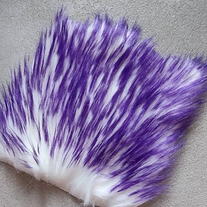 May include: White faux fur with purple streaks. The fur is soft and fluffy, and the streaks are evenly distributed throughout the fur.
