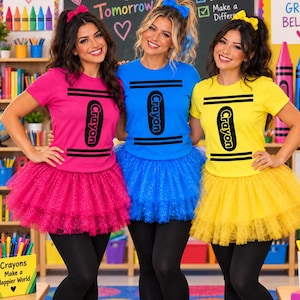 May include: Three t-shirts and matching tulle skirts in bright pink, blue, and yellow. Each shirt features a black crayon graphic with the text Crayon. The outfits include black leggings, white trainers, and matching hair bows in pink, blue, and yellow.