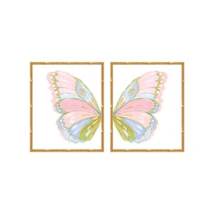 May include: Two square wall art prints in gold bamboo-style frames. Each print features a single butterfly wing painted in soft pastel shades of pink, blue, and green with white highlights, set against a clean, solid white background.