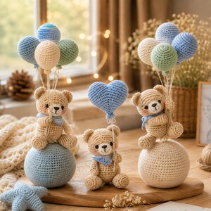 May include: Three crocheted teddy bears in light brown yarn with pink cheeks and blue neckerchiefs. Two bears sit on large spheres, holding clusters of small crocheted balloons in blue, cream, and green. One bear holds a blue crocheted heart balloon.