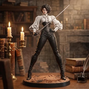 May include: A collectible figurine titled THE LADY DUELIST featuring a person with short dark hair wearing a white ruffled blouse, a black corset, black trousers, and black boots, holding a silver rapier while standing on a circular base.