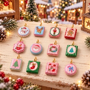 May include: A collection of eleven small, colorful Christmas-themed charms featuring various designs including a snowman, reindeer, nutcracker, gingerbread man, Santa Claus, wreath, Christmas tree, stocking, and candy cane, each with a gold loop.