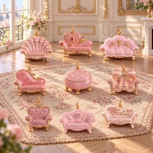 May include: A collection of eight miniature furniture-shaped trinket boxes in shades of pink and gold. The set includes a shell-shaped chair, a heart-shaped chaise, a sofa with cherubs, a curved lounge, a round ottoman, a striped sofa, a crown chair, and two floral sofas.