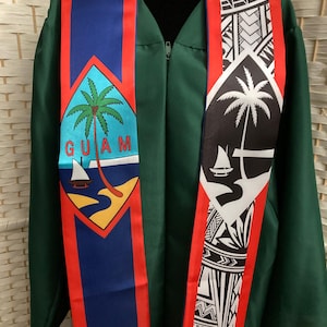 May include: A dark green graduation gown worn with a graduation stole. The left side of the stole features the Guam seal with a palm tree and boat. The right side displays a black and white tribal pattern with a palm tree and boat graphic.
